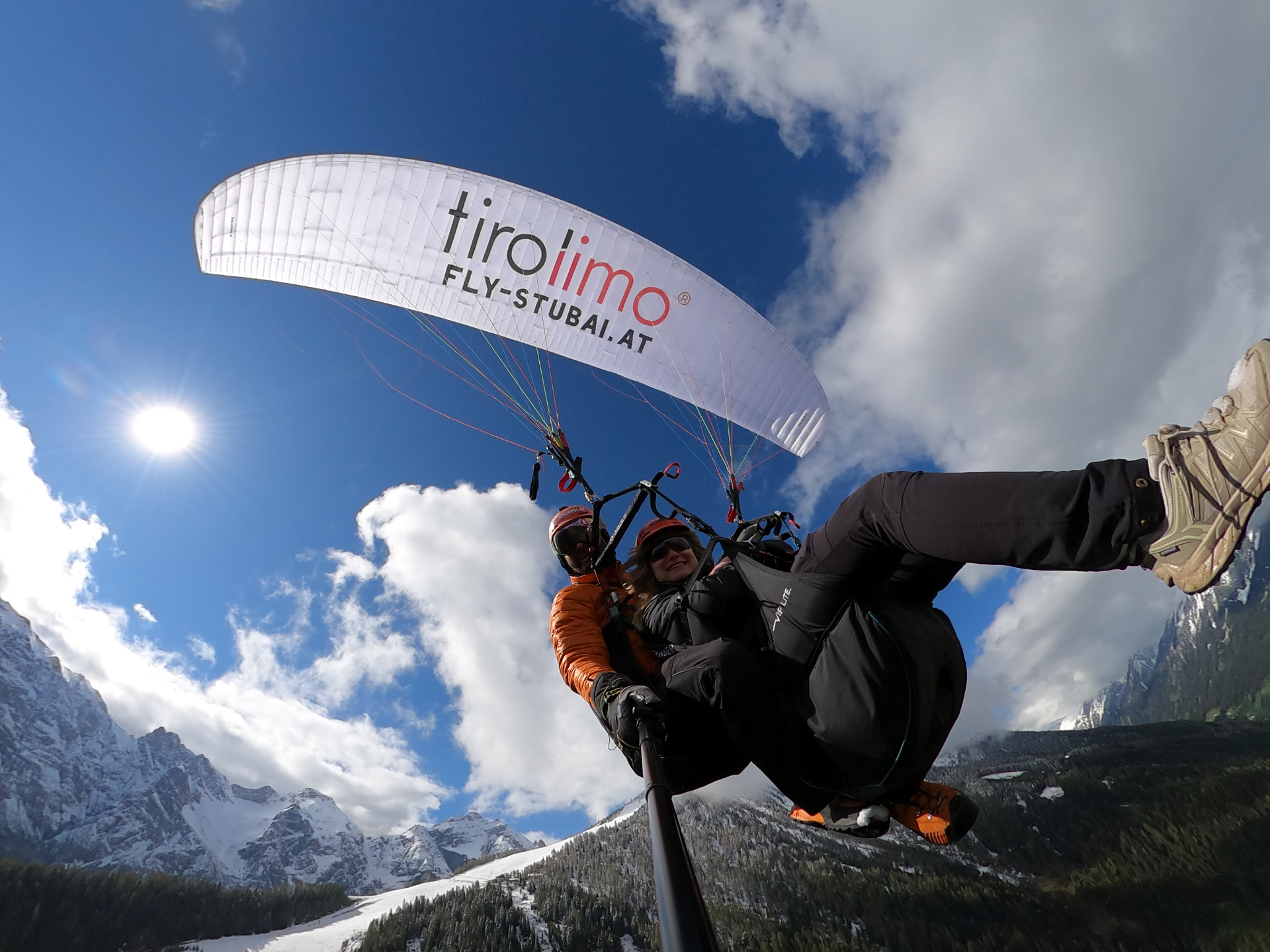 Tandem-Paragliding über dem winterlichen Stubaital mit Blick auf schneebedeckte Berge nahe Innsbruck